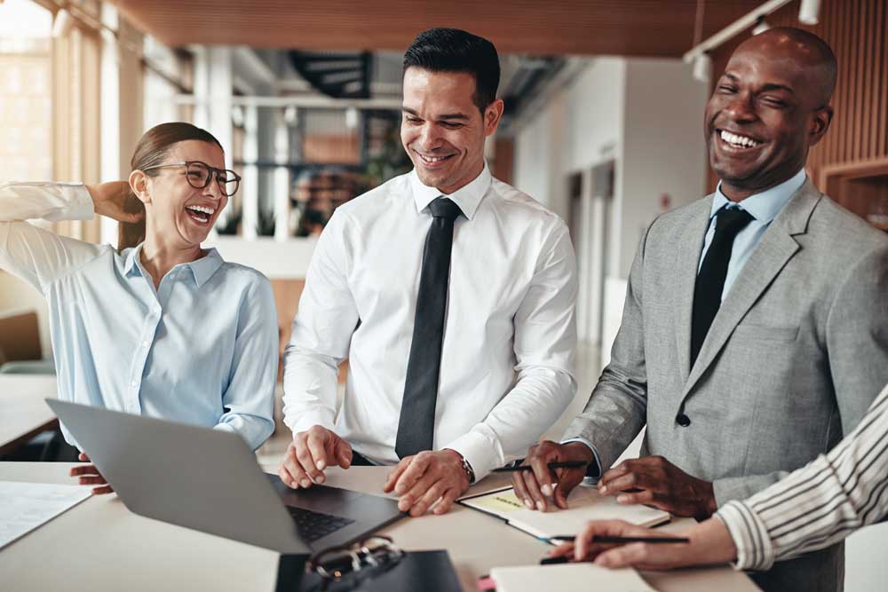 ADS diverse business executives managers thirties laughing standing at table 307179279 Curve Content