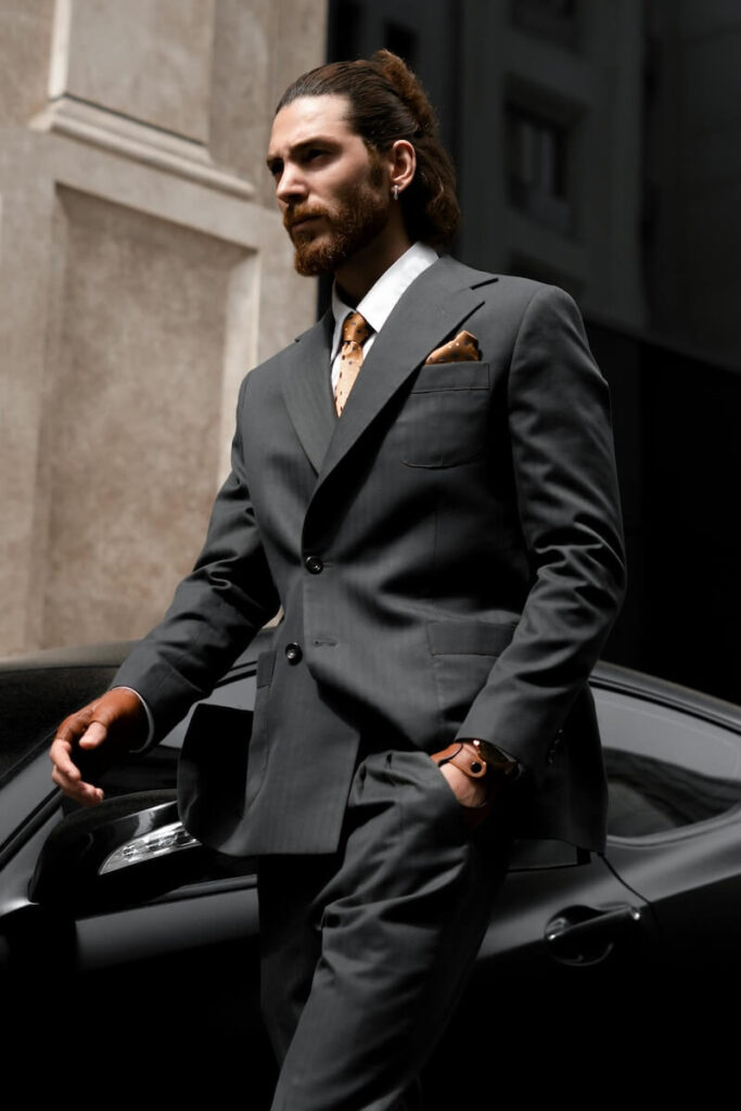 Young-business-executive-designer-suit-gray-red-tie-walking-by-fancy-car