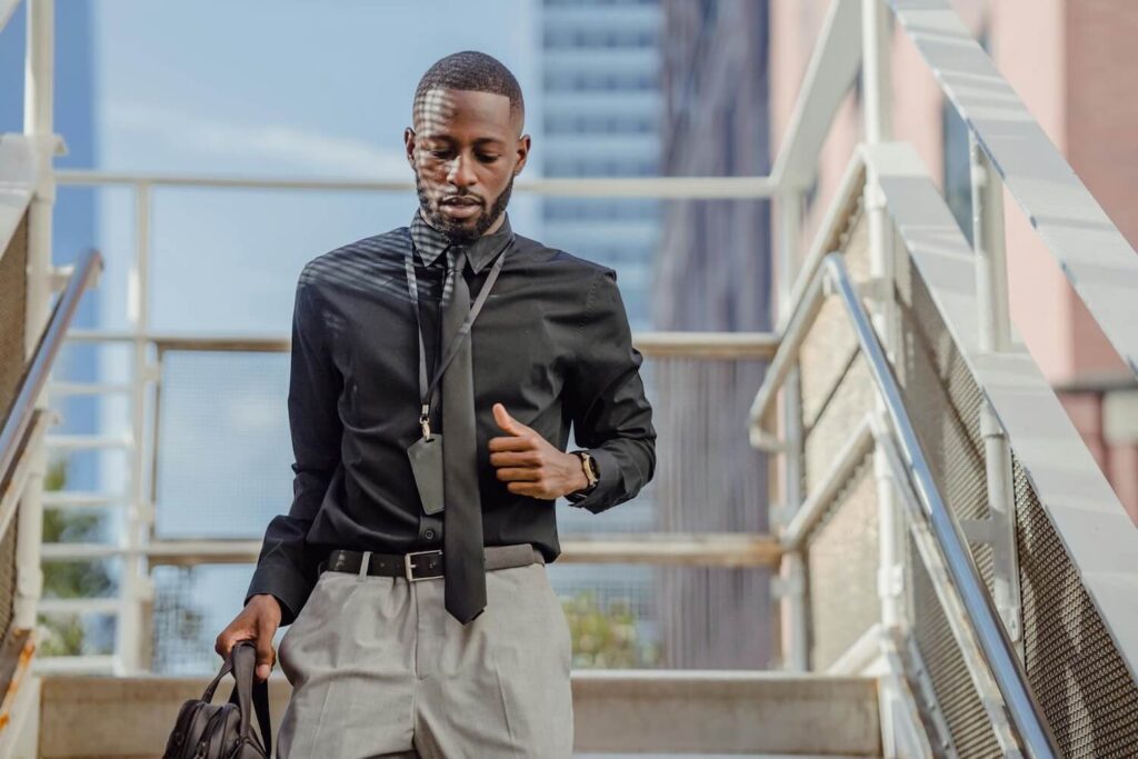 PX young stylish man black shirt tie walking down stairs compressed Curve Content