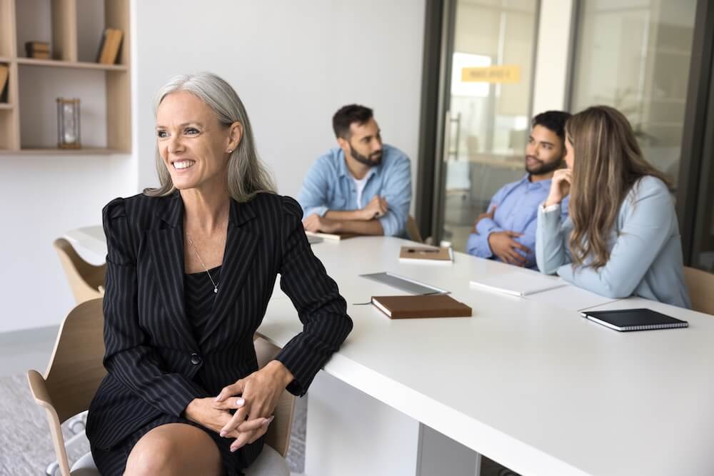 ad female executive smiling with her team Curve Content